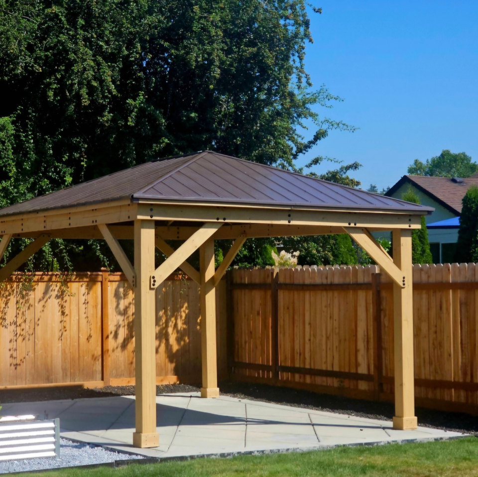 Wood-framed gazebo with a metal roof over a backyard patio