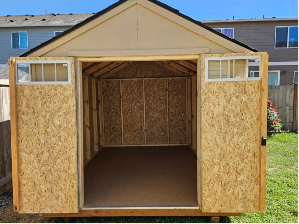 Wooden storage shed with double doors open
