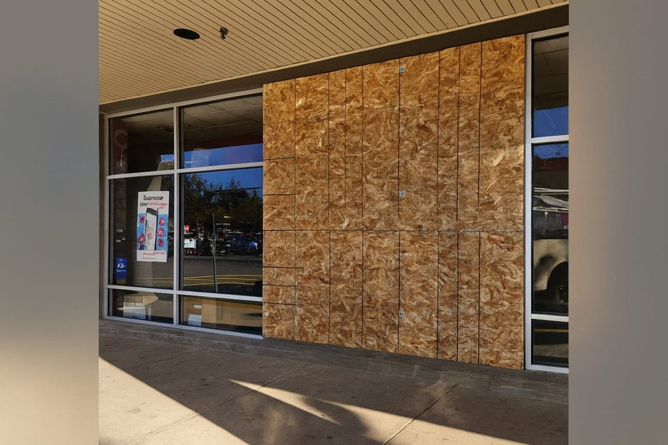 Commercial storefront opening protected with plywood panels